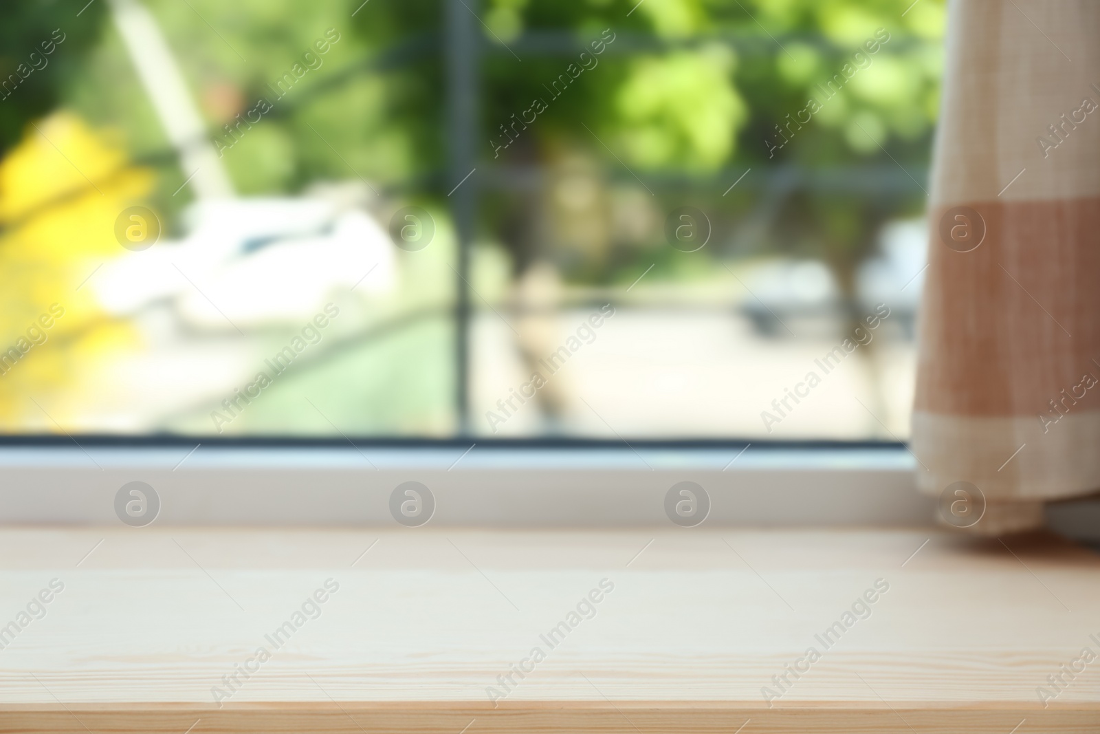 Photo of Closeup view of window with empty wooden sill