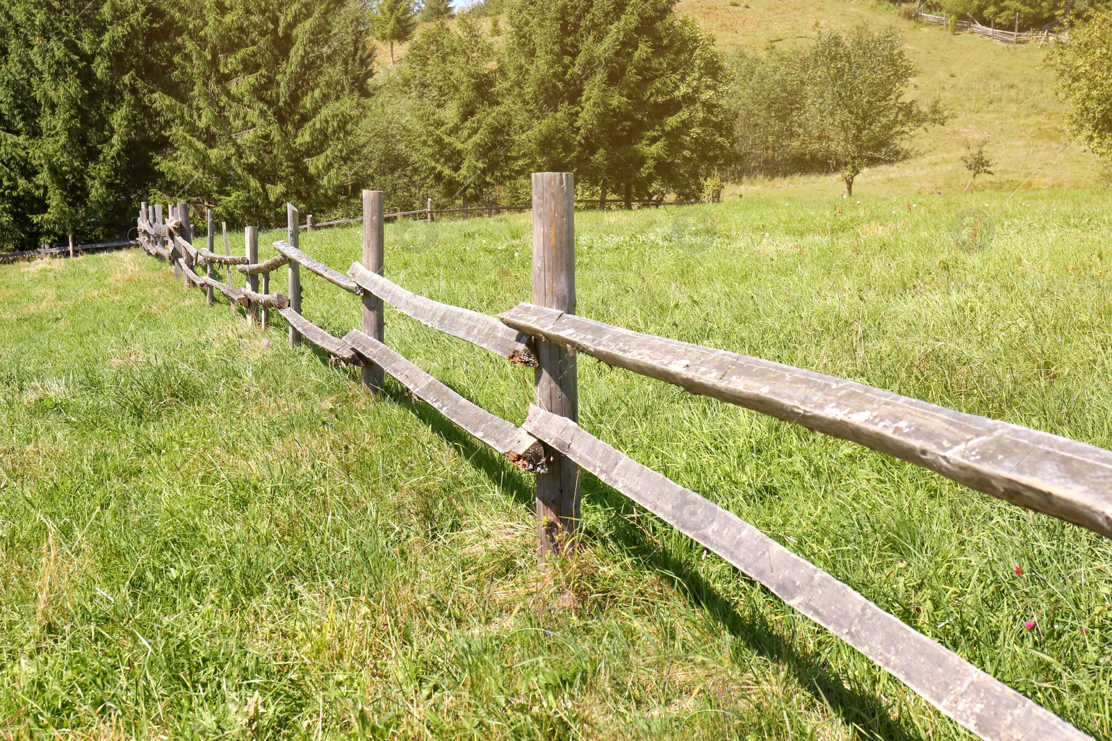 Photo of Beautiful view of mountain countryside with wooden fence