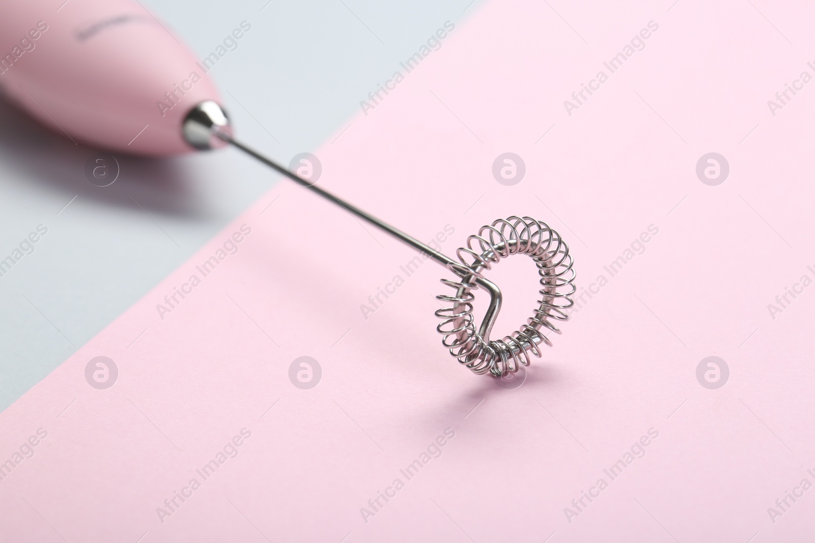 Photo of Pink milk frother wand on color background, closeup