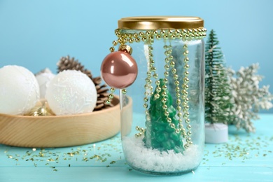 Photo of Handmade snow globe and Christmas decorations on table