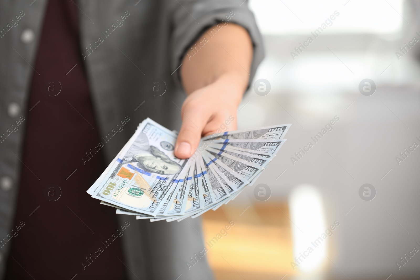 Photo of Man with American money on blurred background, closeup