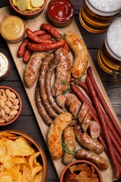 Photo of Set of different tasty snacks and beer on wooden table, flat lay