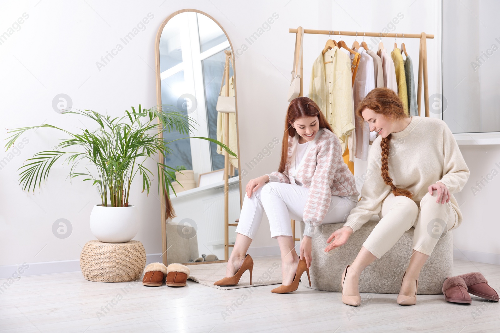 Photo of Beautiful young sisters shopping together in boutique