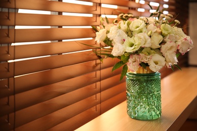 Photo of Bouquet of beautiful flowers on window sill in room, space for text. Interior design