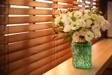 Bouquet of beautiful flowers on window sill in room, space for text. Interior design