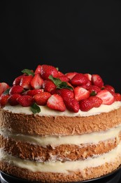 Photo of Tasty cake with fresh strawberries and mint on black background, closeup