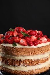 Tasty cake with fresh strawberries and mint on black background, closeup