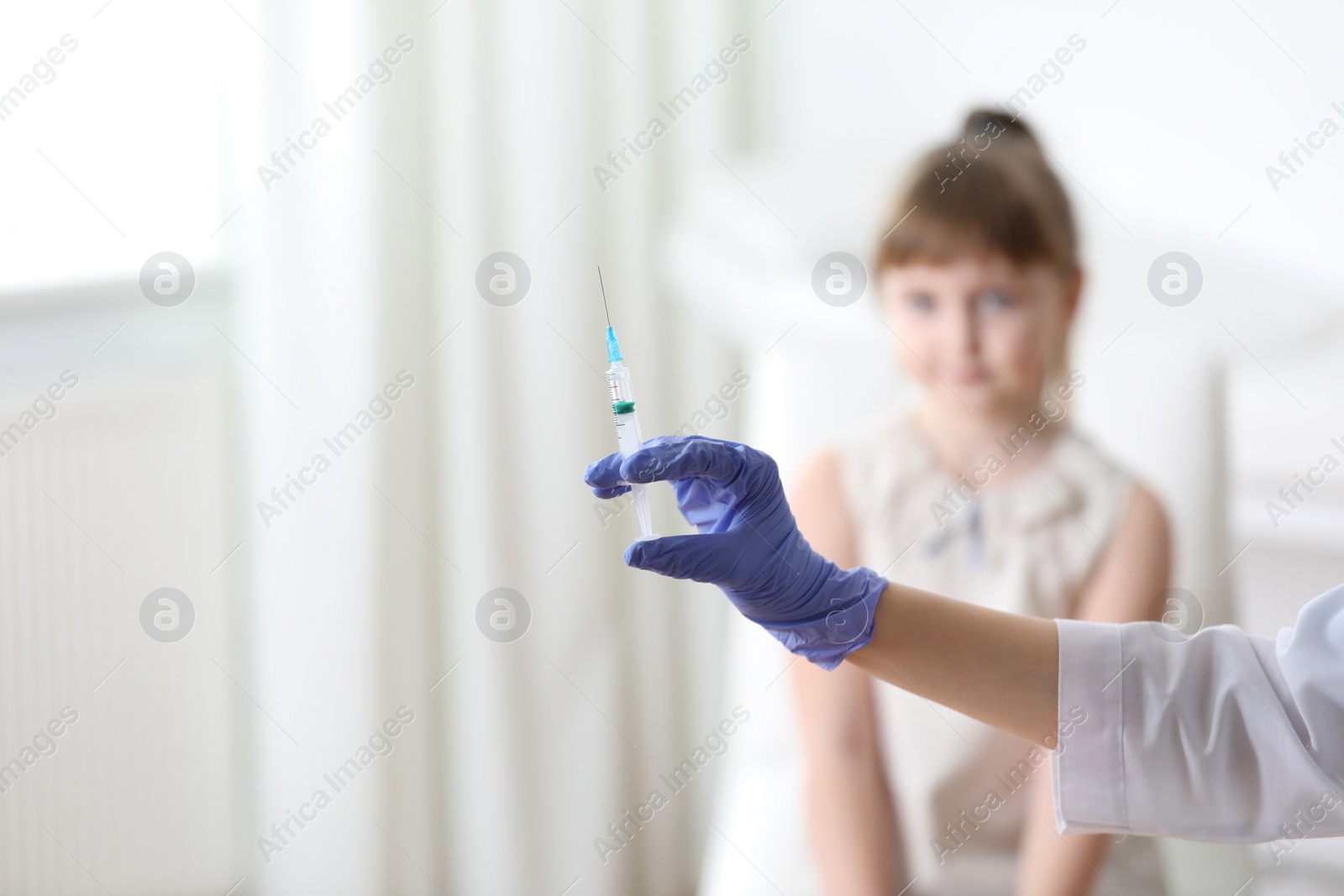 Photo of Doctor holding syringe with chickenpox vaccine for child in clinic, closeup. Varicella virus prevention