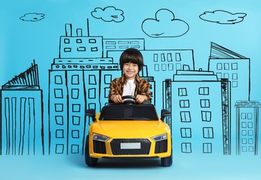 Image of Cute little boy driving toy car and drawing of city on light blue background