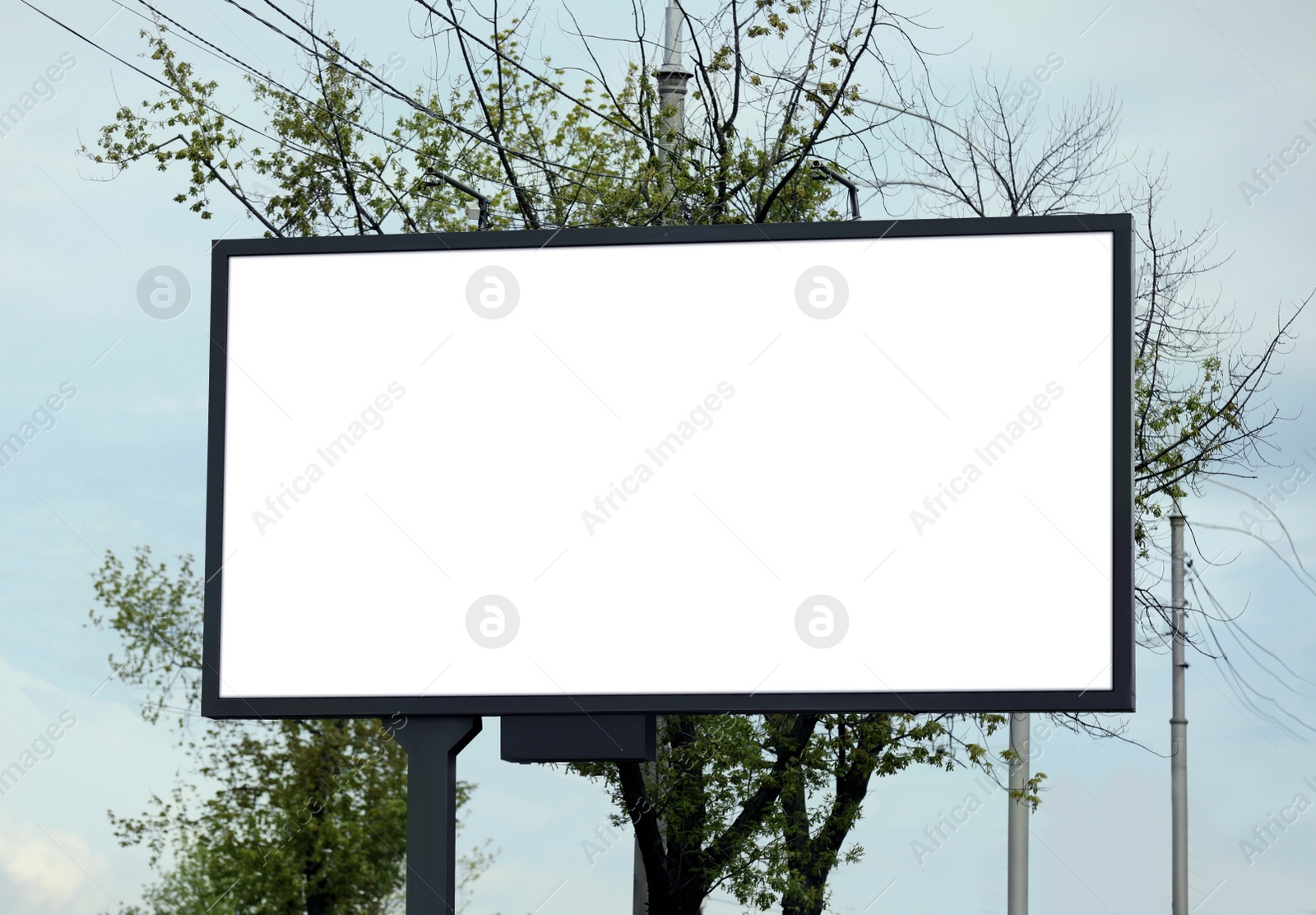 Photo of Blank advertising board in city. Mockup for design