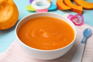 Photo of Bowl of healthy baby food on wooden table