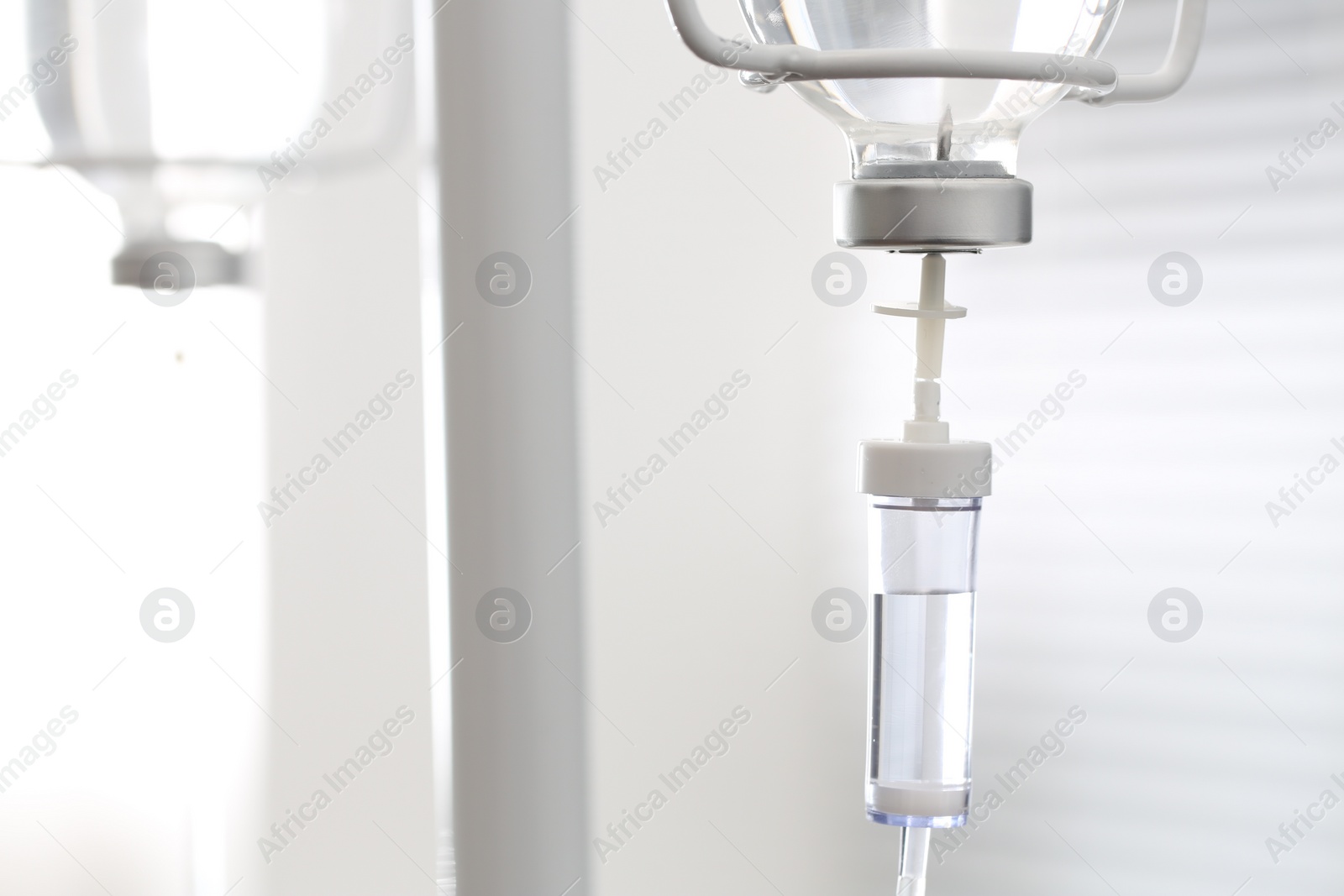 Photo of IV drip against blurred background, space for text