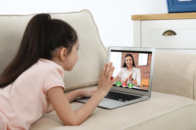 Image of Distance learning, studying at home. Girl having online school lesson during quarantine and lockdown due to Covid-19 pandemic