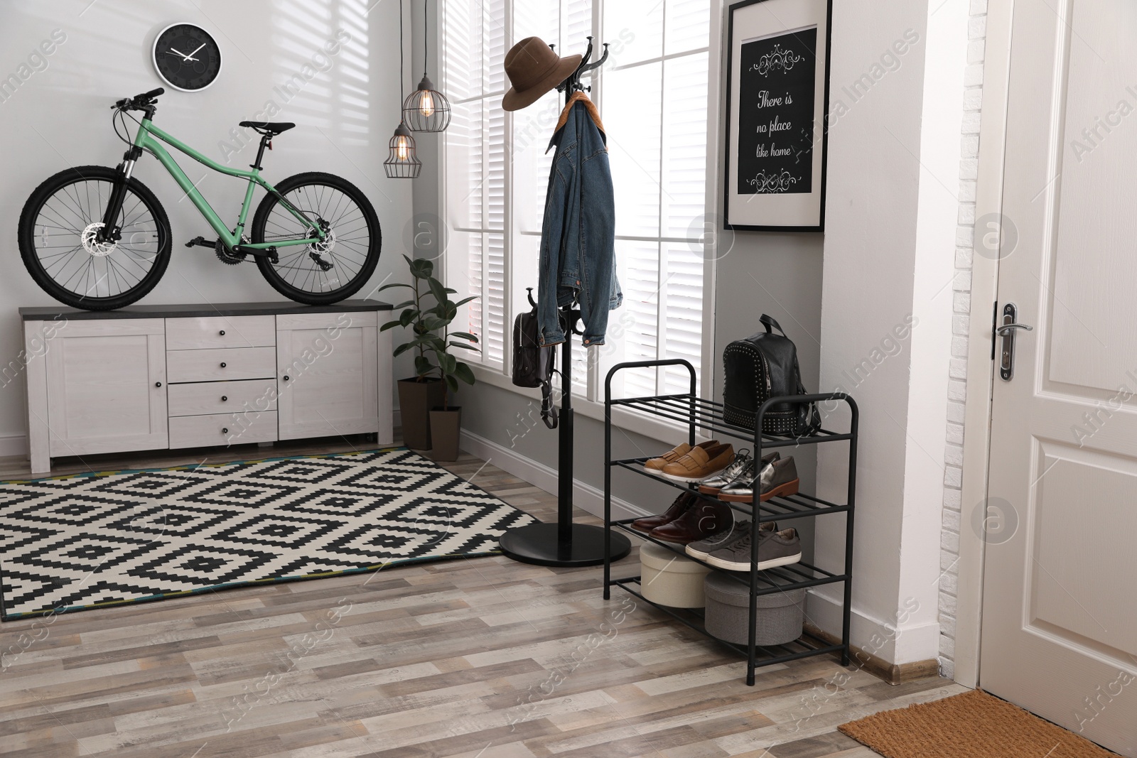 Photo of Hallway interior with stylish furniture and green bicycle