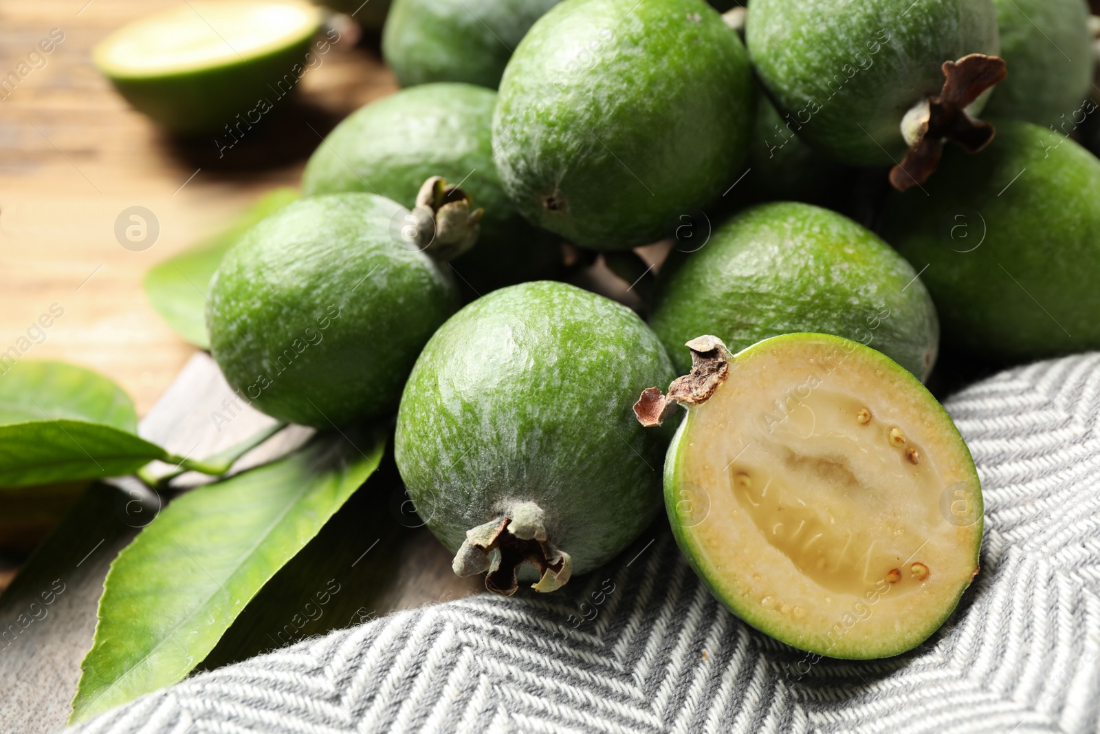 Photo of Composition with fresh green feijoa fruits on table, closeup