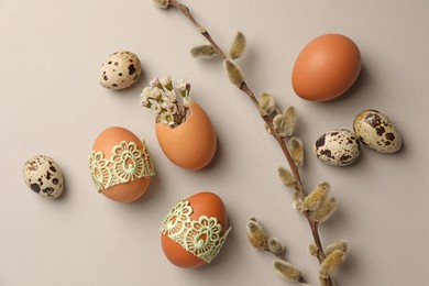 Flat lay composition with eggs and natural decor on light grey background. Happy Easter