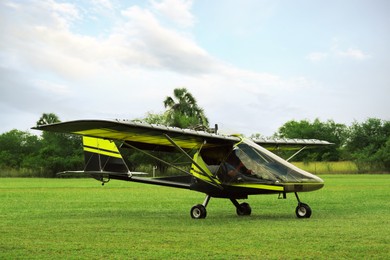 Photo of Modern light aircraft on green grass outdoors