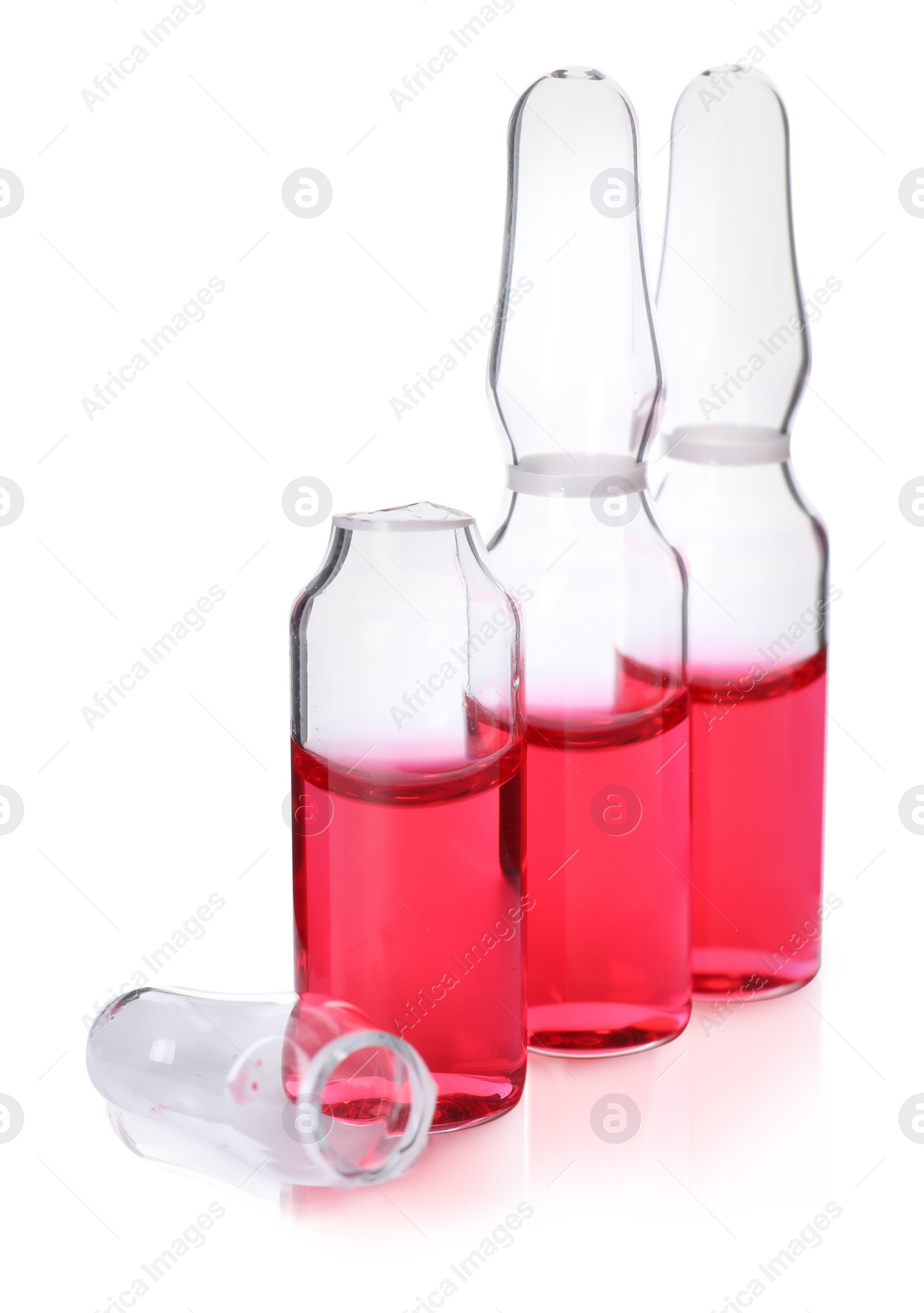 Photo of Open and closed glass ampoules with pharmaceutical product on white background