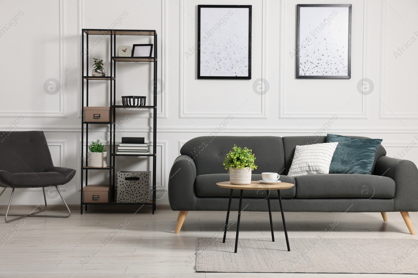 Photo of Stylish room interior with potted artificial plants, coffee table and sofa