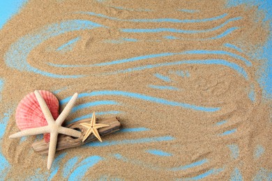 Piece of wood with beautiful starfishes and sand on blue background, flat lay. Space for text