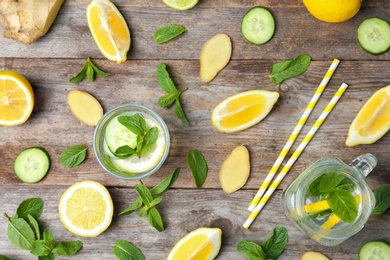 Flat lay composition with detox lemonade and ingredients on wooden background