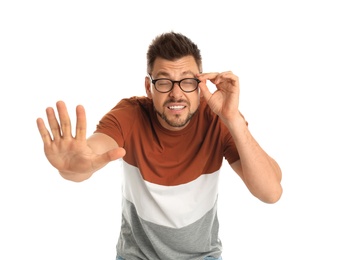 Photo of Man with vision problems wearing glasses on white background