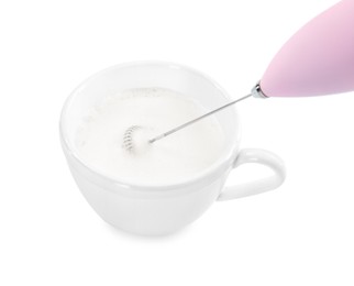 Whisking milk in cup with mini mixer (frother wand) isolated on white