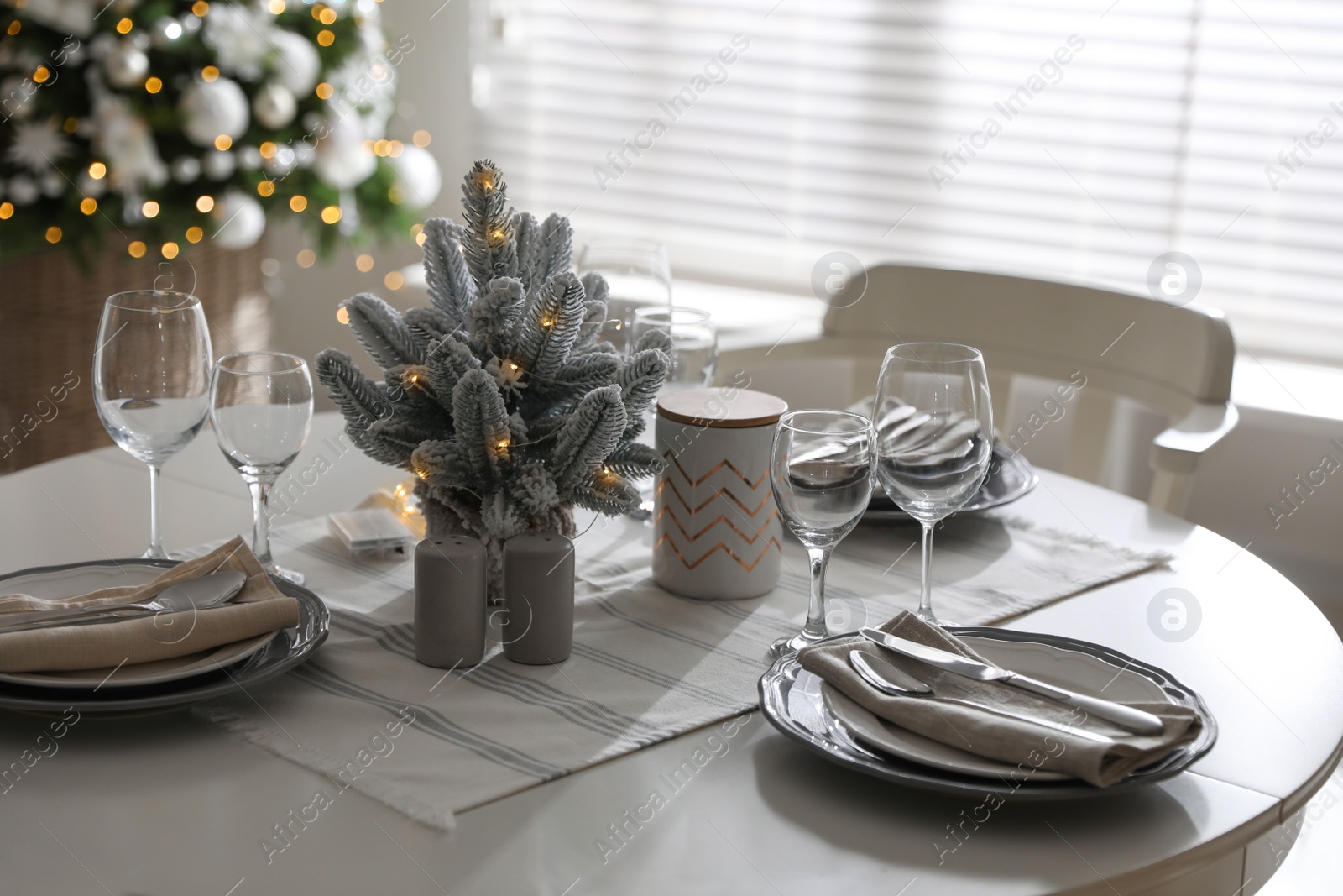 Photo of Festive table setting and beautiful Christmas decor indoors. Interior design