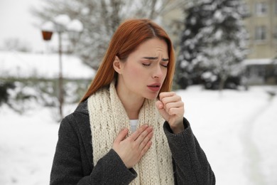 Photo of Beautiful young woman coughing outdoors. Cold symptoms