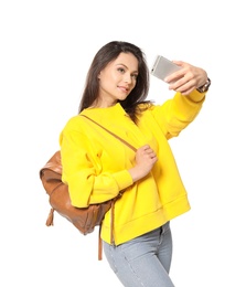 Attractive young woman taking selfie on white background