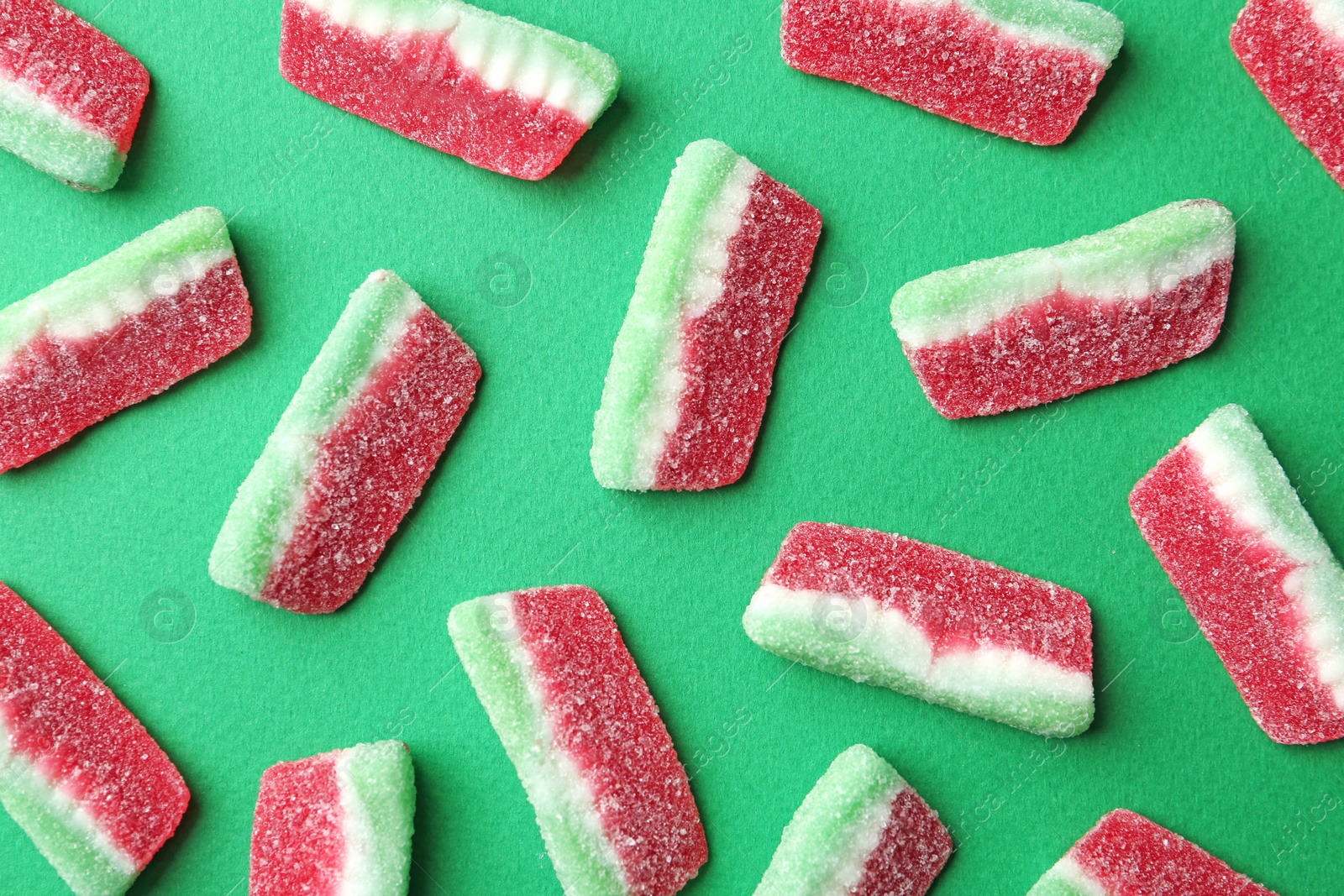 Photo of Flat lay composition with delicious jelly candies on color background