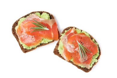 Delicious sandwiches with salmon, avocado and rosemary on white background, top view