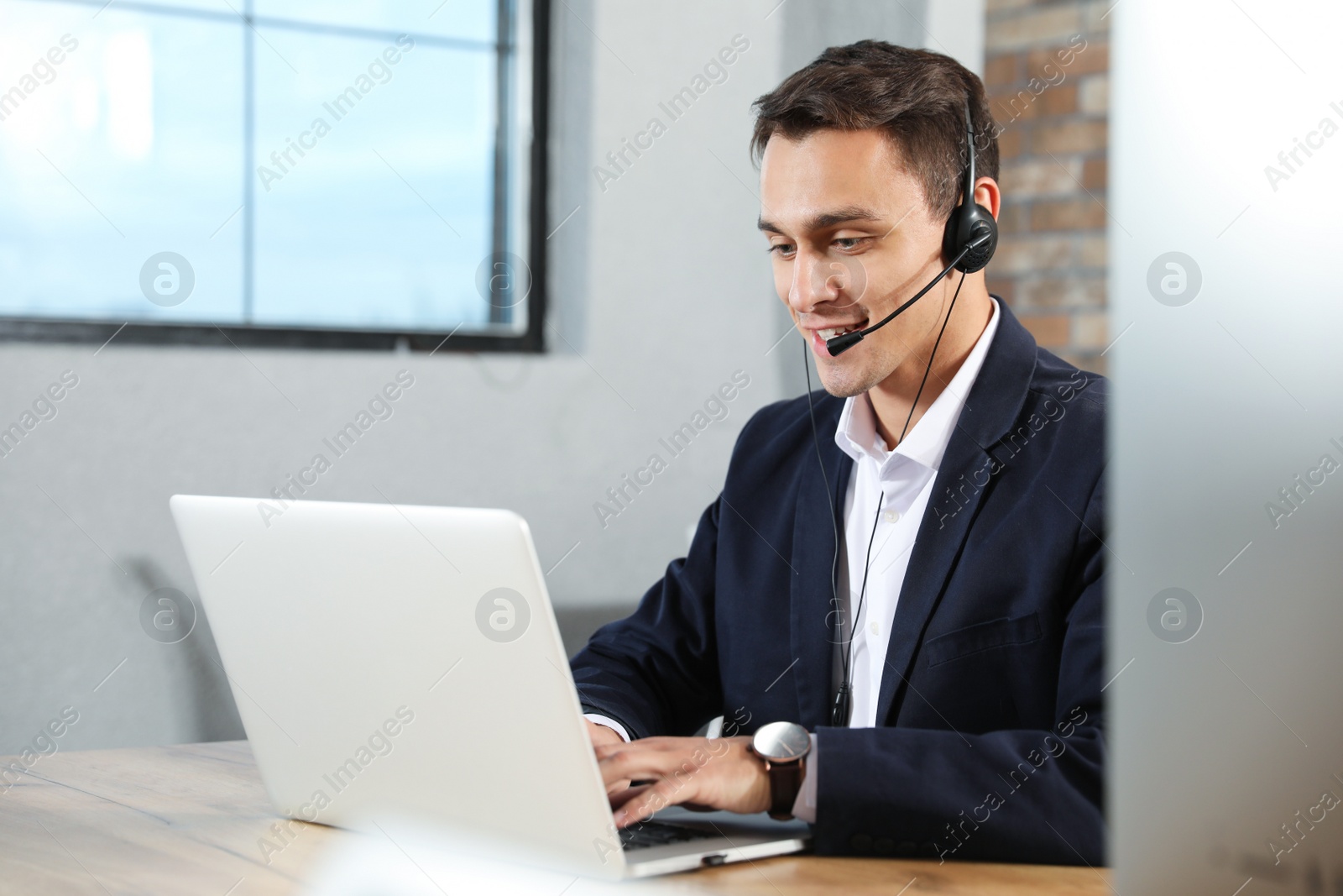 Photo of Technical support operator with headset in modern office