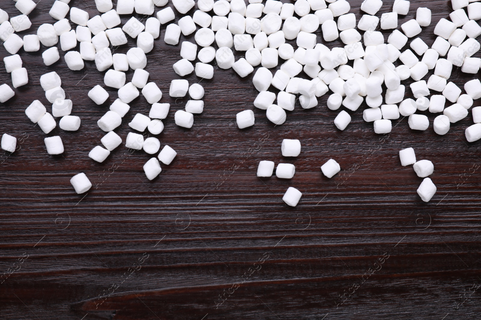 Photo of Delicious marshmallows on wooden table, flat lay. Space for text