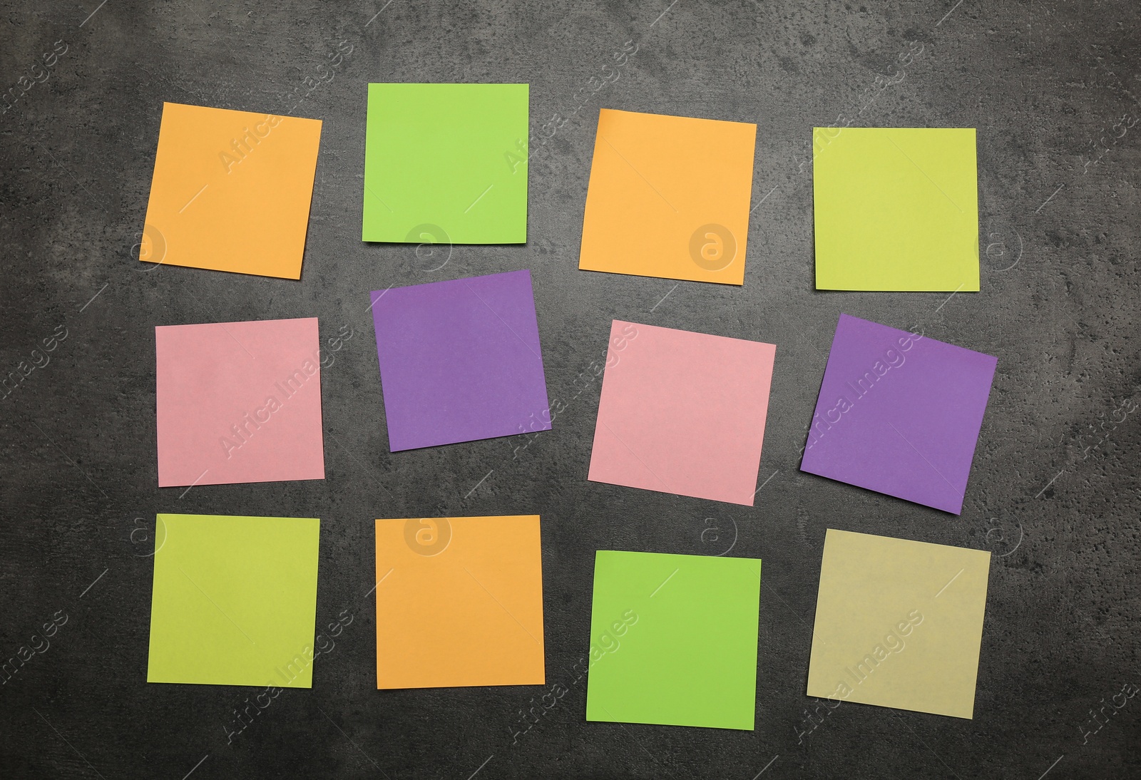 Photo of Colorful stickers on grey stone table, flat lay