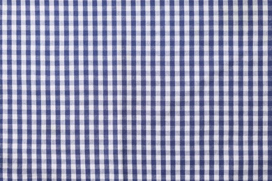 Blue checkered tablecloth as background, top view