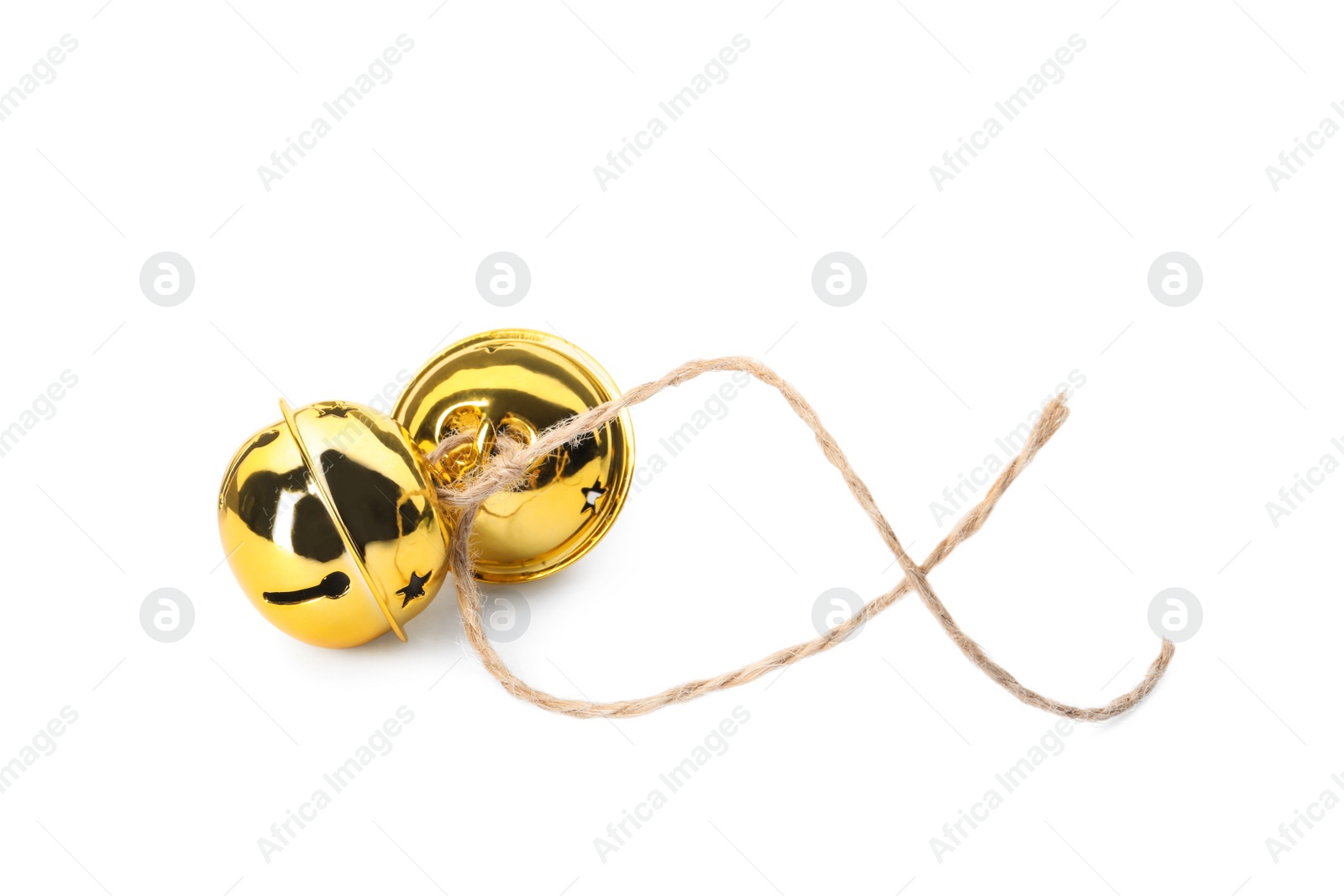 Photo of Shiny golden sleigh bells on white background