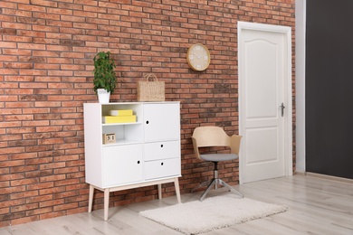 Photo of Chest of drawers in stylish living room interior