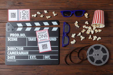 Flat lay composition with clapperboard, cinema tickets and 3d glasses on wooden table