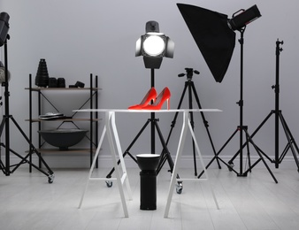 Photo of Professional photography equipment prepared for shooting stylish shoes in studio