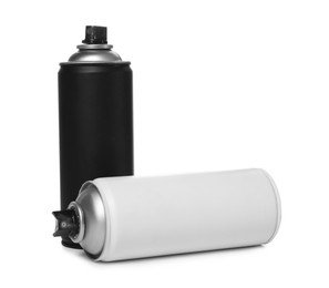 Photo of Cans of different spray paints on white background. Graffiti supplies