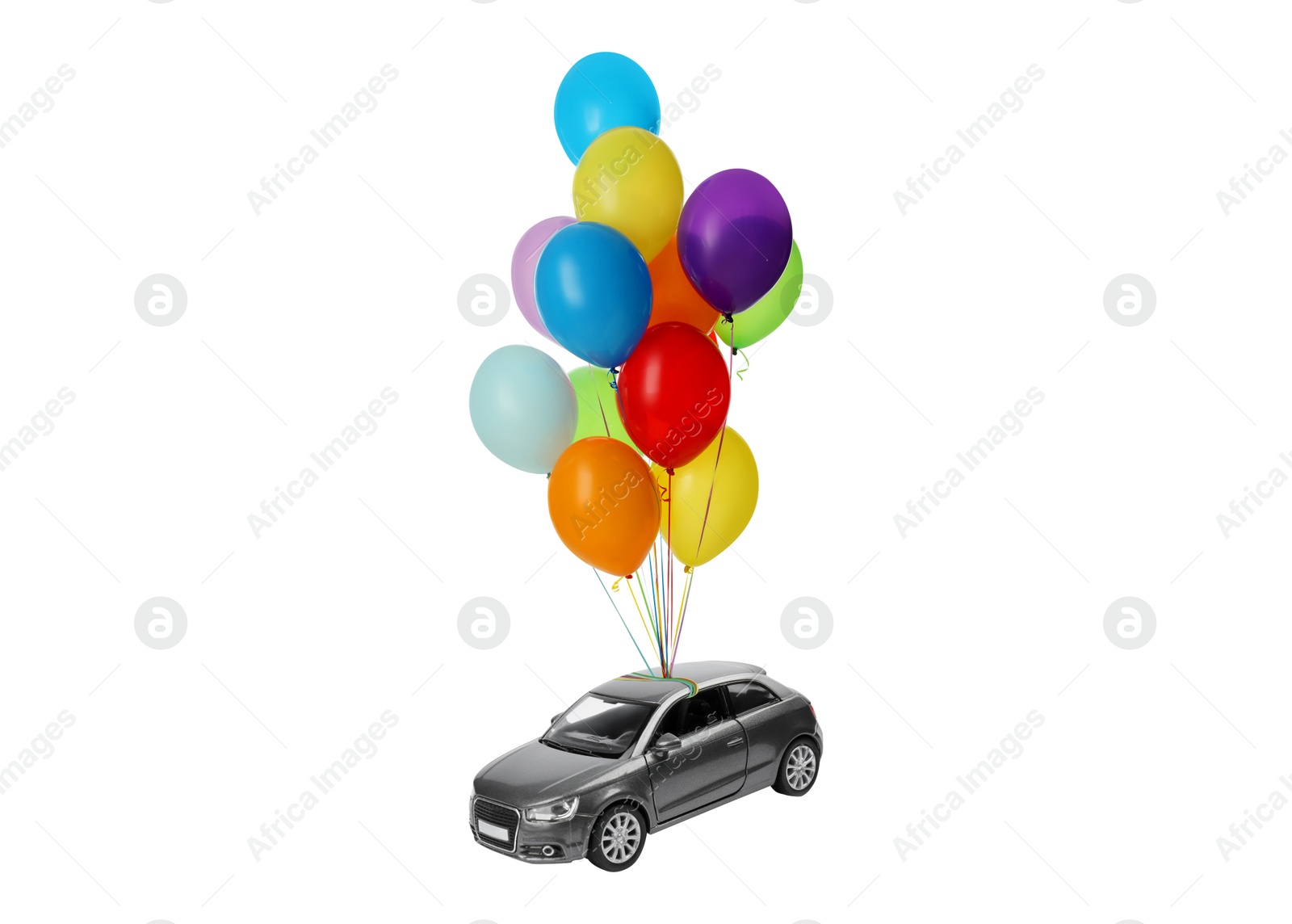 Image of Many balloons tied to toy car flying on white background