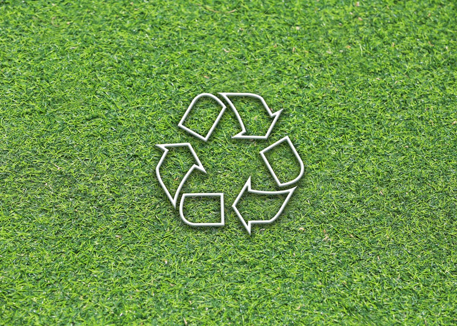 Image of Green grass and illustration of recycling symbol