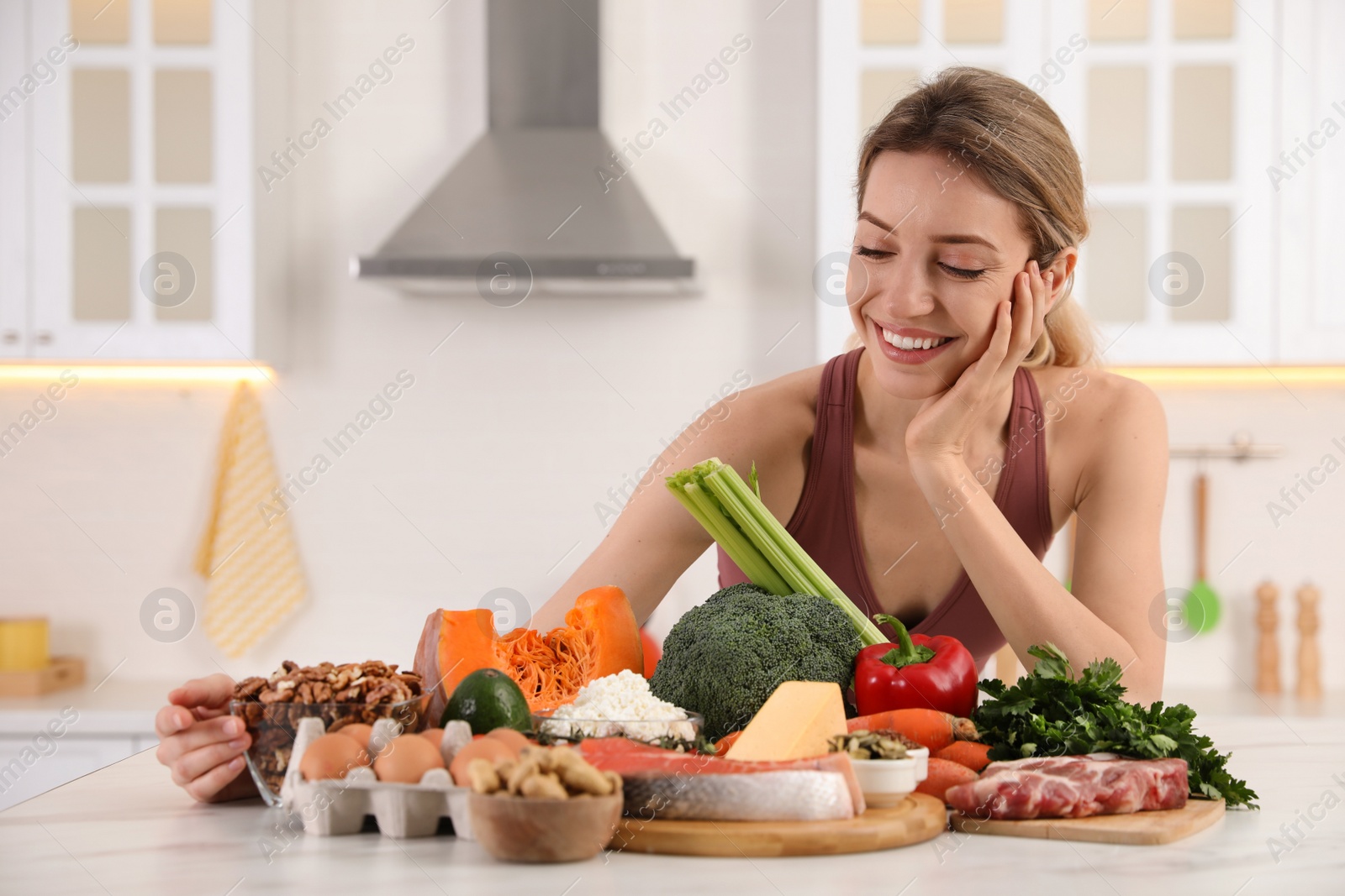 Photo of Woman with healthy food in kitchen. Keto diet