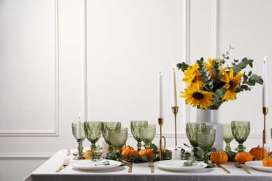 Photo of Beautiful autumn table setting with bouquet indoors. Plates, cutlery, glasses and floral decor