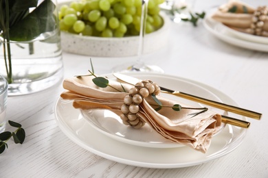 Elegant festive table setting on white wooden table