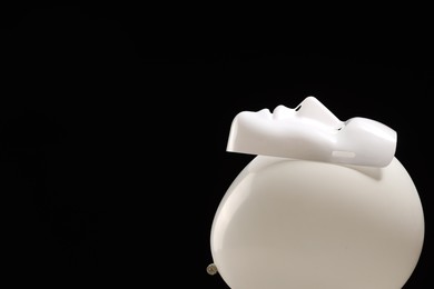 Photo of Theatrical performance. Plastic mask and white balloon on black background, space for text