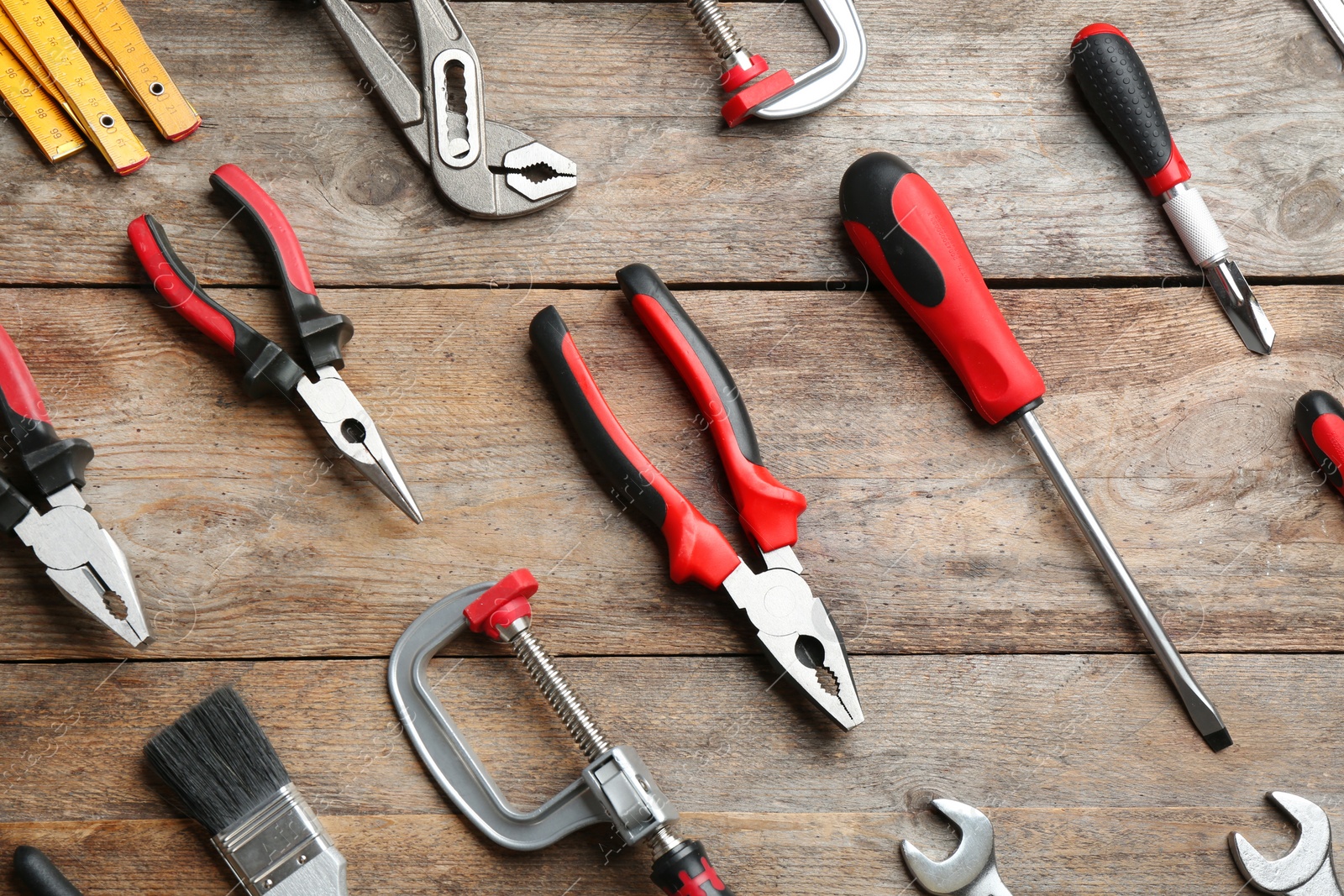 Photo of Flat lay composition with construction tools on wooden background