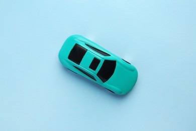 One bright car on light blue background, top view. Children`s toy