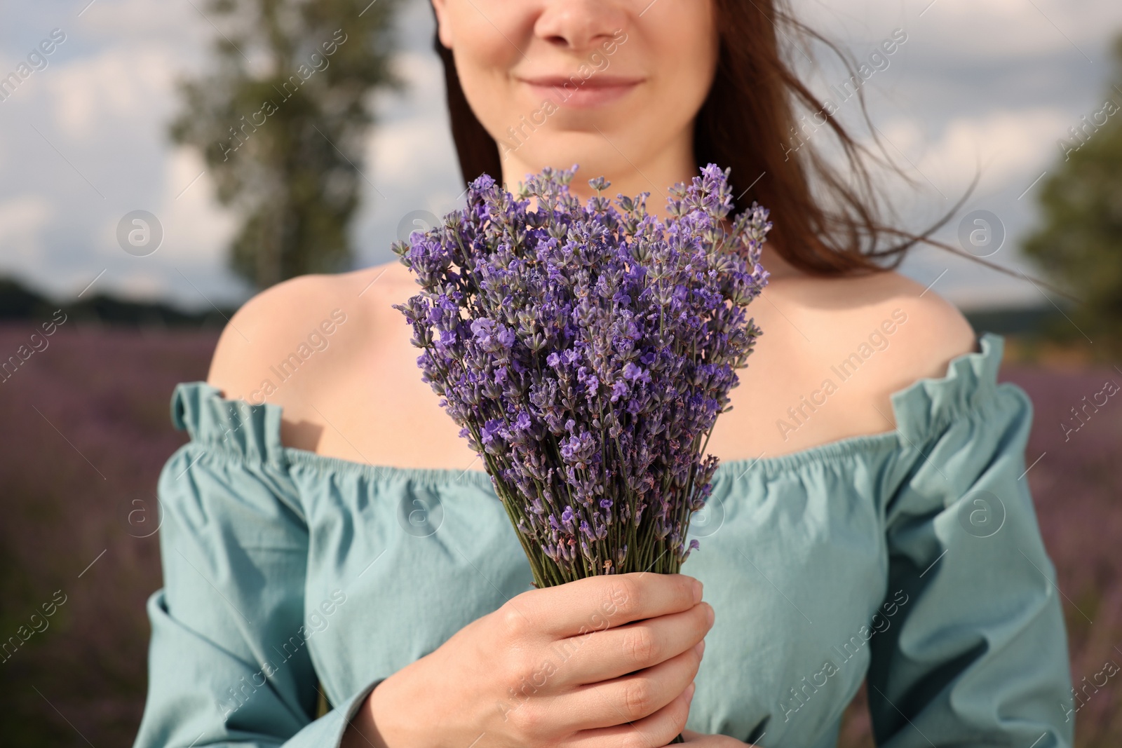 Photo of Woman with bouquet of lavender outdoors, closeup